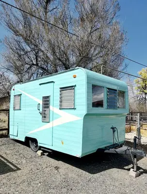 a blue trailer parked in a parking lot at Cute Vintage Caravan for a Peaceful Escape in Niwot, Colorado in Niwot