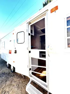 an open door of a white trailer with a door open at Cute Vintage Caravan for a Peaceful Escape in Niwot, Colorado in Niwot