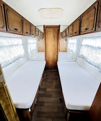 an empty room with two beds in an rv at Cute Vintage Caravan for a Peaceful Escape in Niwot, Colorado in Niwot
