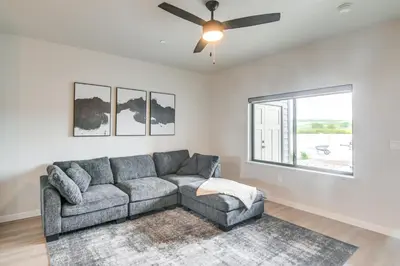 a living room with a couch and a ceiling fan at Granby Ranch Escape Shuttle to the Slopes! in Granby