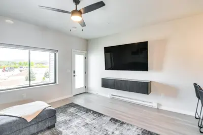 a living room with a flat screen tv and a couch at Granby Ranch Escape Shuttle to the Slopes! in Granby