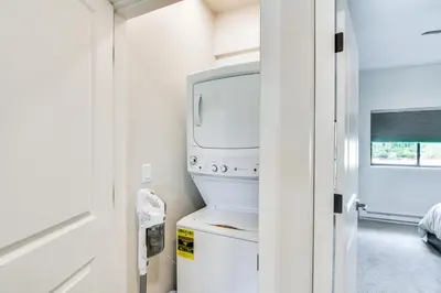 a kitchen with a white refrigerator and a tv at Granby Ranch Escape Shuttle to the Slopes! in Granby