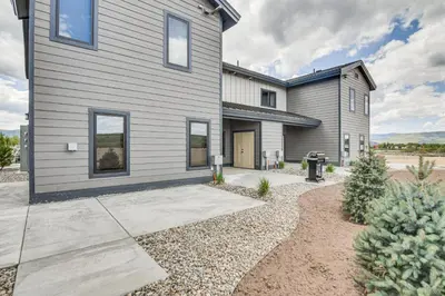 a gray house with a gravel driveway at Granby Ranch Escape Shuttle to the Slopes! in Granby