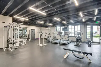 a gym with several treadmills and machines at Granby Ranch Escape Shuttle to the Slopes! in Granby