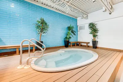 a jacuzzi tub in a room with plants at 2 Mi to Winter Park Slopes Mtn-View Condo! in Winter Park