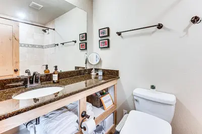 a bathroom with a sink and a toilet at 2 Mi to Winter Park Slopes Mtn-View Condo! in Winter Park