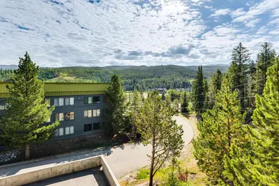 an aerial view of a building with trees at 2 Mi to Winter Park Slopes Mtn-View Condo! in Winter Park