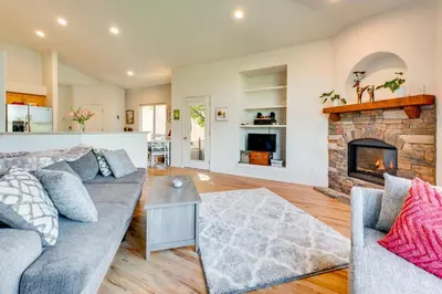 a living room with a couch and a fireplace at Pet-Friendly Longmont Home with McIntosh Lake Access in Longmont