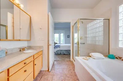 a bathroom with a tub and a shower and a sink at Pet-Friendly Longmont Home with McIntosh Lake Access in Longmont
