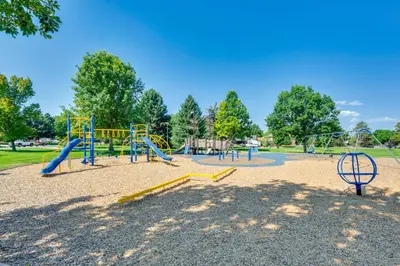 a park with a playground with slides and swings at Pet-Friendly Longmont Home with McIntosh Lake Access in Longmont