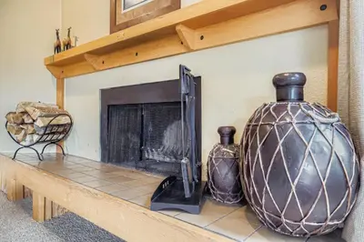 a fireplace with two vases sitting on a table at 1702 The Willows condo in Keystone
