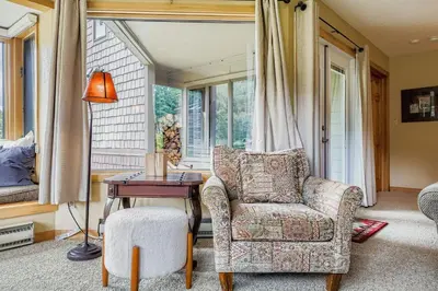 a living room with a chair and a table at 1702 The Willows condo in Keystone