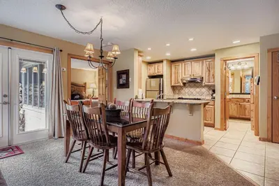 a kitchen and dining room with a table and chairs at 1702 The Willows condo in Keystone