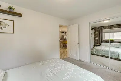 a bedroom with a bed and a mirror at Modern Wheat Ridge Home about 5 Mi to Dtwn Denver in Wheat Ridge
