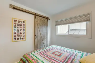 a bedroom with a bed with a colorful blanket on it at Modern Wheat Ridge Home about 5 Mi to Dtwn Denver in Wheat Ridge