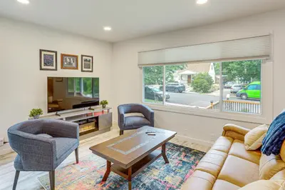 a living room with a couch and chairs and a tv at Modern Wheat Ridge Home about 5 Mi to Dtwn Denver in Wheat Ridge