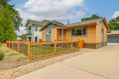 a house with a wooden fence in front of it at Modern Wheat Ridge Home about 5 Mi to Dtwn Denver in Wheat Ridge