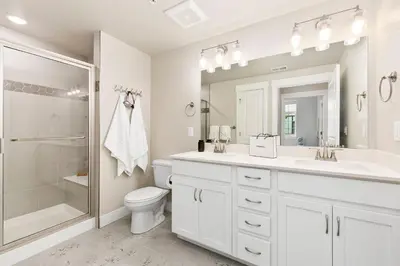 a bathroom with a toilet and a sink and a shower at Northfield Old Town Flat with Attached Garage and EV in Fort Collins