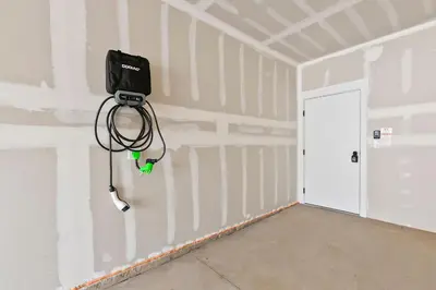 a room with a hose hanging on the wall at Northfield Old Town Flat with Attached Garage and EV in Fort Collins