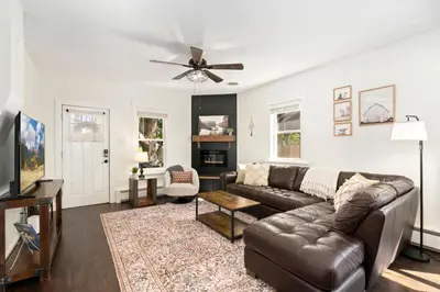 a living room with a couch and a ceiling fan at Windsor Farmhouse Family Fun, Yard and Fireplace in Windsor