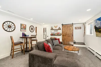 a living room with a couch and a table at Windsor Farmhouse Family Fun, Yard and Fireplace in Windsor