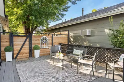 a patio with a table and chairs and a fence at Windsor Farmhouse Family Fun, Yard and Fireplace in Windsor