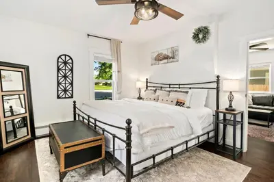 a bedroom with a bed and a ceiling fan at Windsor Farmhouse Family Fun, Yard and Fireplace in Windsor
