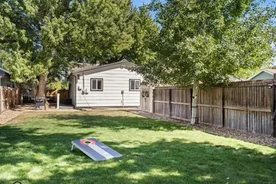 a backyard with a wooden fence and a trampoline at Windsor Farmhouse Family Fun, Yard and Fireplace in Windsor
