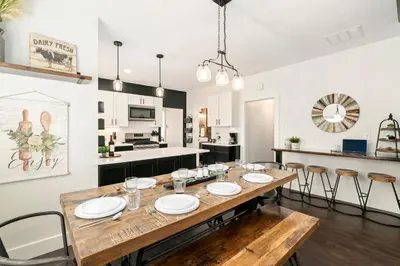a dining room and kitchen with a wooden table and chairs at Windsor Farmhouse Family Fun, Yard and Fireplace in Windsor