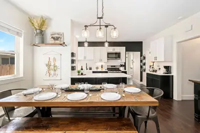 a kitchen and dining room with a wooden table and chairs at Windsor Farmhouse Family Fun, Yard and Fireplace in Windsor