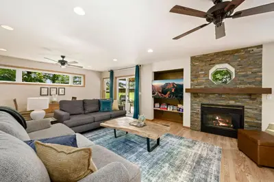 a living room with a couch and a fireplace at Shady Grove with 4 King Beds, Dog Run and Outdoor Fun in Loveland