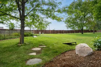 a park with a tree and a bench and a rock at Shady Grove with 4 King Beds, Dog Run and Outdoor Fun in Loveland