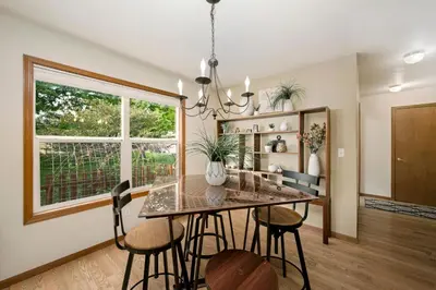 a dining room with a table and chairs and a window at Shady Grove with 4 King Beds, Dog Run and Outdoor Fun in Loveland