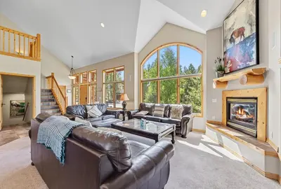 a living room with leather furniture and a fireplace at Modern Mountain Stay Hot Tub Fire Pit and Views in Silverthorne