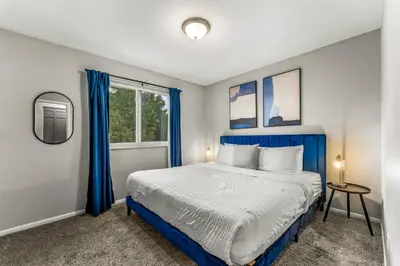 a bedroom with a blue bed and a window at Modern 4BR Family Friendly Retreat with Hot tub in Arvada