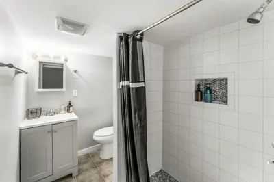 a bathroom with a shower curtain and a toilet at Modern 4BR Family Friendly Retreat with Hot tub in Arvada