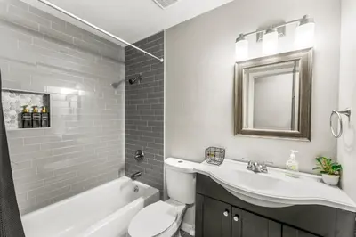 a bathroom with a sink and a toilet and a bath tub at Modern 4BR Family Friendly Retreat with Hot tub in Arvada