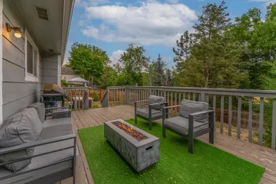 a patio with two chairs and a fire pit on a deck at Modern 4BR Family Friendly Retreat with Hot tub in Arvada