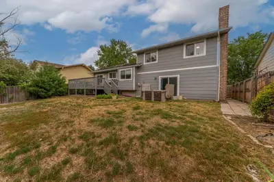 a house with a yard in front of it at Modern 4BR Family Friendly Retreat with Hot tub in Arvada