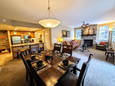 a dining room and living room with a table and chairs at Amenities Deck Level, Walk to Gondola WP Resort in Winter Park