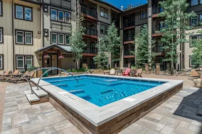 a swimming pool in front of a apartment building at Amenities Deck Level, Walk to Gondola WP Resort in Winter Park