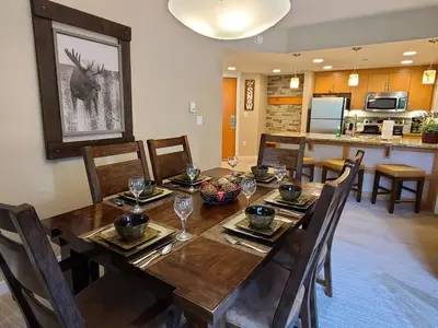 a dining room with a wooden table and chairs at Amenities Deck Level, Walk to Gondola WP Resort in Winter Park