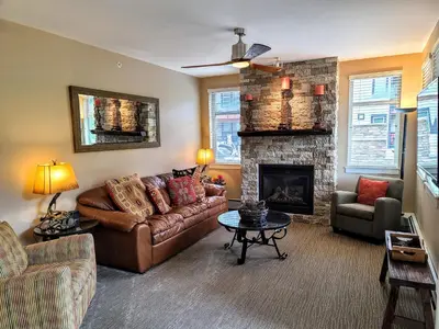 a living room with a couch and a fireplace at Amenities Deck Level, Walk to Gondola WP Resort in Winter Park