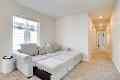 a white couch in a living room with a window at Less Than 2 Mi to Gaylord Rockies Remote-Work Hub with Gym! in Aurora