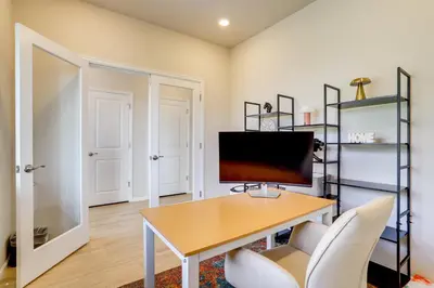 a home office with a desk and a television at Less Than 2 Mi to Gaylord Rockies Remote-Work Hub with Gym! in Aurora