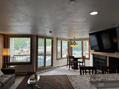 a living room with a flat screen tv and a fireplace at Studio in Lakeside Village, Updated Kitchen & Bath apts in Keystone