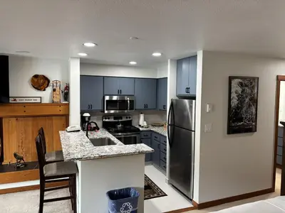 a kitchen with a stainless steel refrigerator and a counter at Studio in Lakeside Village, Updated Kitchen & Bath apts in Keystone