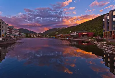 a view of a river in a town at sunset at Studio in Lakeside Village, Updated Kitchen & Bath apts in Keystone