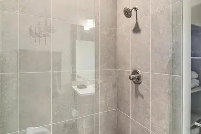 a bathroom with a shower with a glass door at Brand-New Townhome with Hot Tub, 4 Mi to Winter Park in Fraser