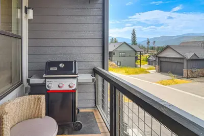 a grill on the balcony of a house at Brand-New Townhome with Hot Tub, 4 Mi to Winter Park in Fraser